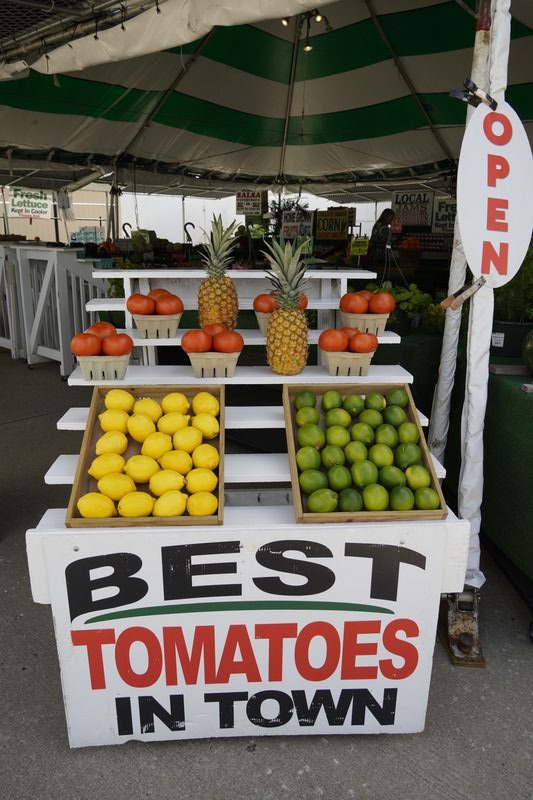 Colorful fruit cart with lemons, limes, oranges, and pineapple